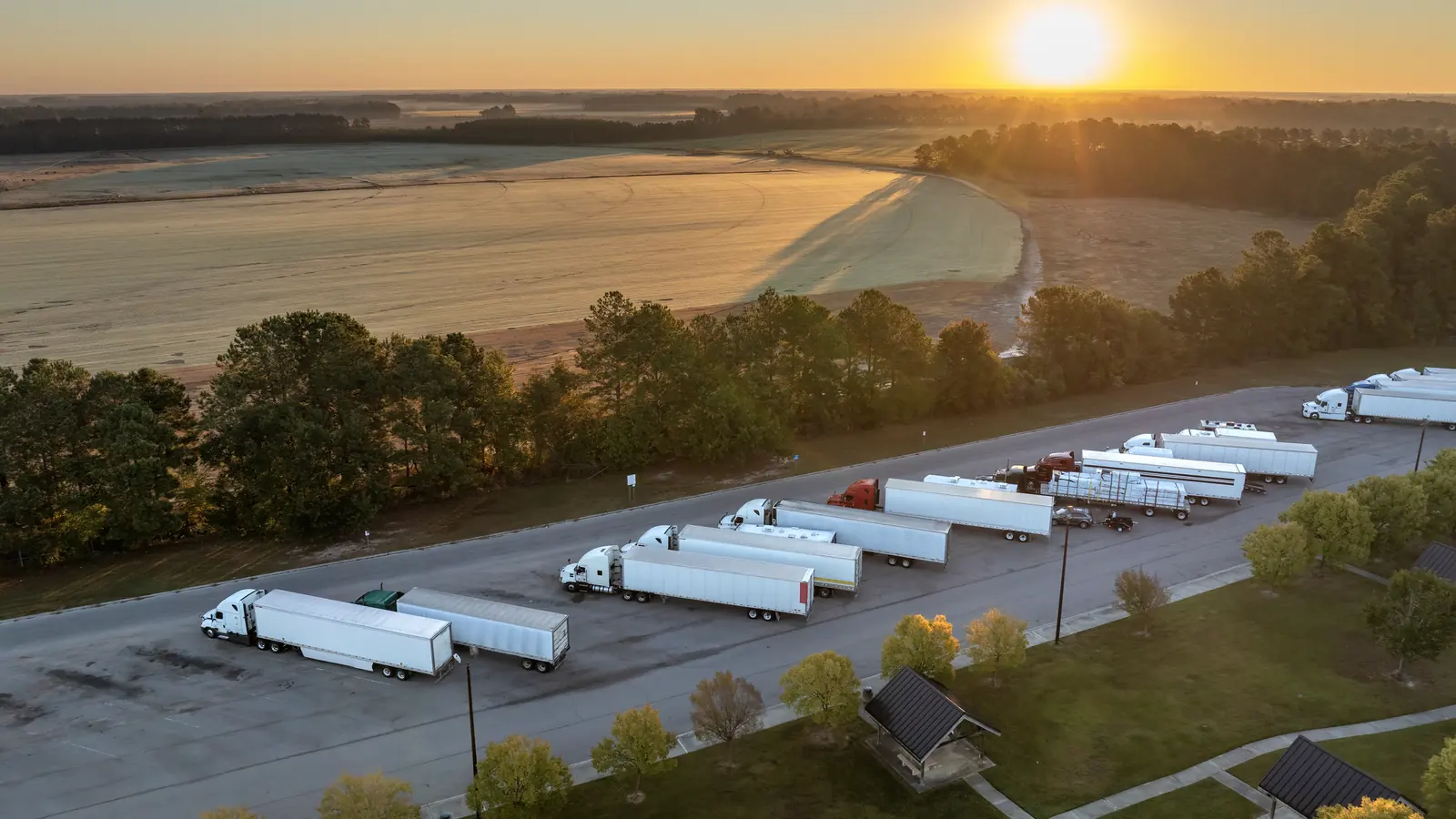 Trailers lined up across a freight yard at sunrise